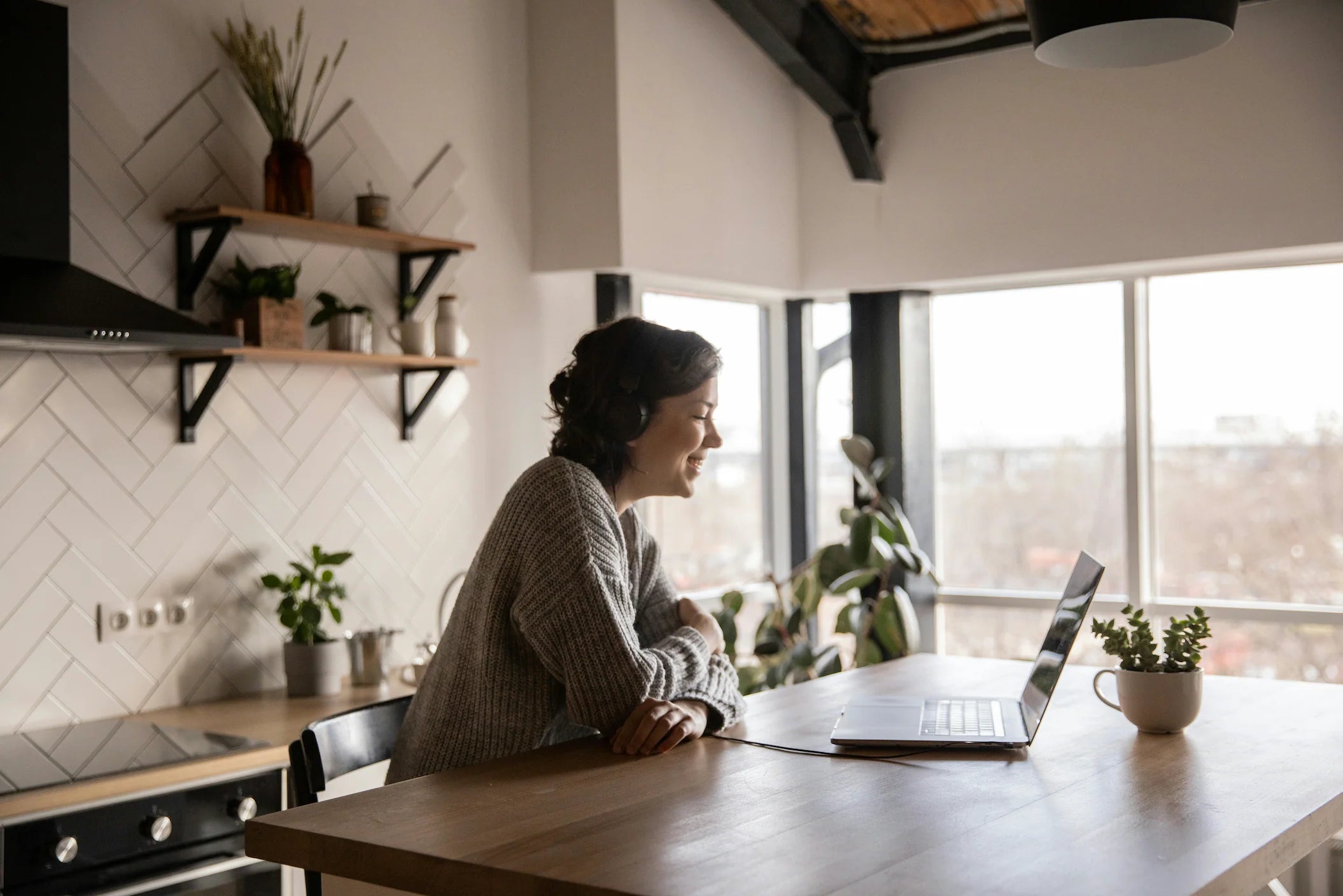 A woman at her kitchen table with her laptop, from The Health Institute’s website